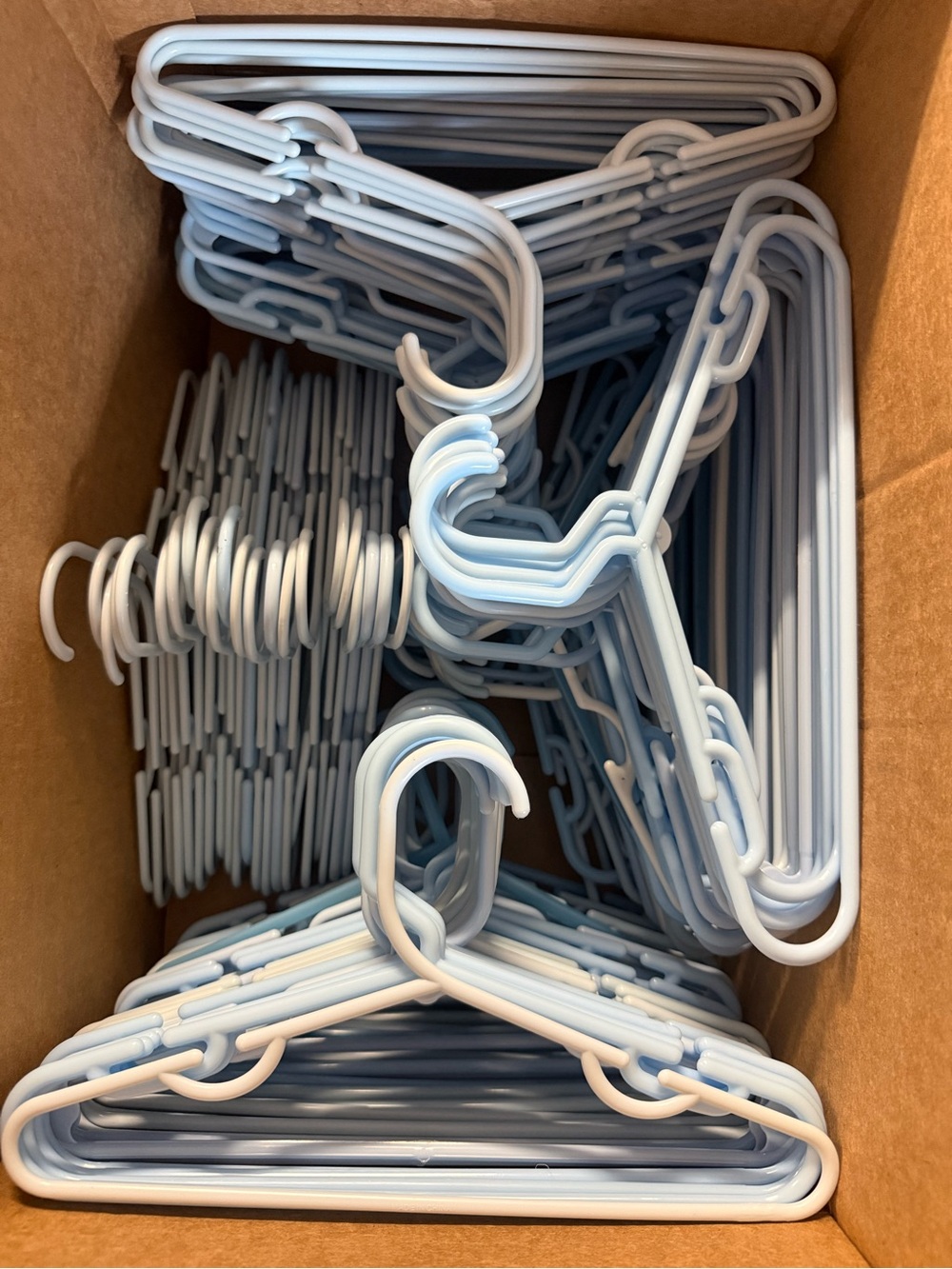 Bulk lot of over 159 light blue baby and children’s hangers for closets